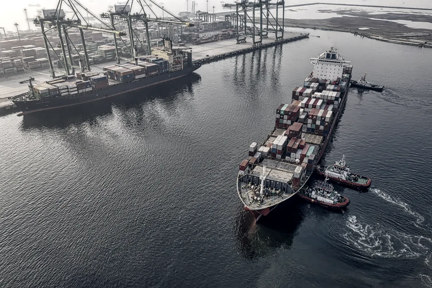 Container ship berthing in port at first light